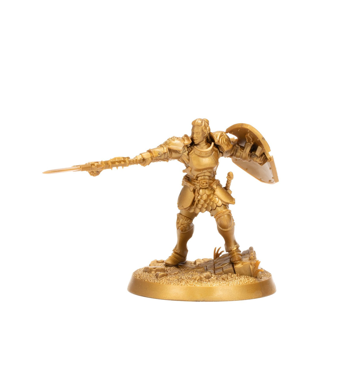A gold miniature of a female warrior in full armor holding a spear pointed forward and a shield