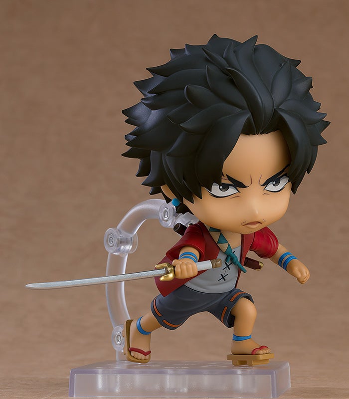 Chibi anime figure of a young man in a red jacket holding a sword