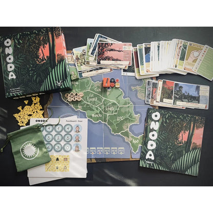 Full setup of the board game ONODA, showing the map, cards, tokens, and box against a dark background