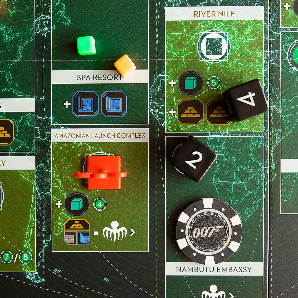 A close-up of a James Bond-themed board game, displaying a map board with game pieces including black dice, coloured cubes and a 007 poker chip
