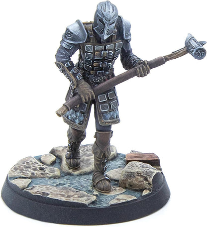 A miniature of a grey armored warrior with a horned helmet, holding a two-handed hammer, standing on a rocky base.