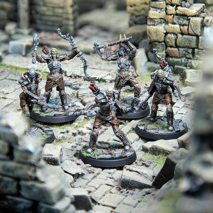 Five armored skeletal warrior miniatures wield bows, axes, and swords on rocky ruins.