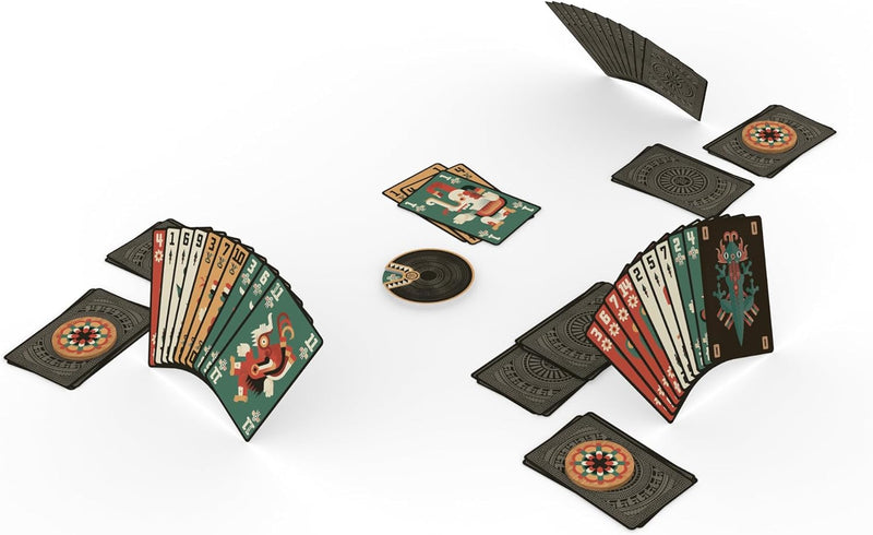 Two hands of Aztec-inspired playing cards are spread out on a white surface with several face-down cards and a disc-shaped marker