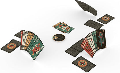 Two hands of Aztec-inspired playing cards are spread out on a white surface with several face-down cards and a disc-shaped marker