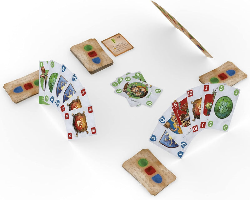 Tabletop view of a card game with fantasy-themed cards and game pieces spread out on a white surface