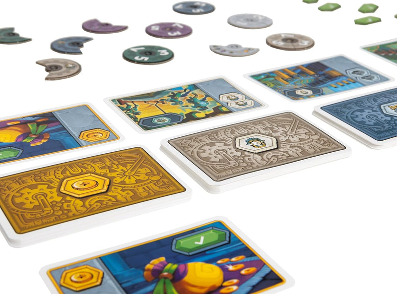 A close-up view of various game pieces including cards and tokens laid out on a white surface