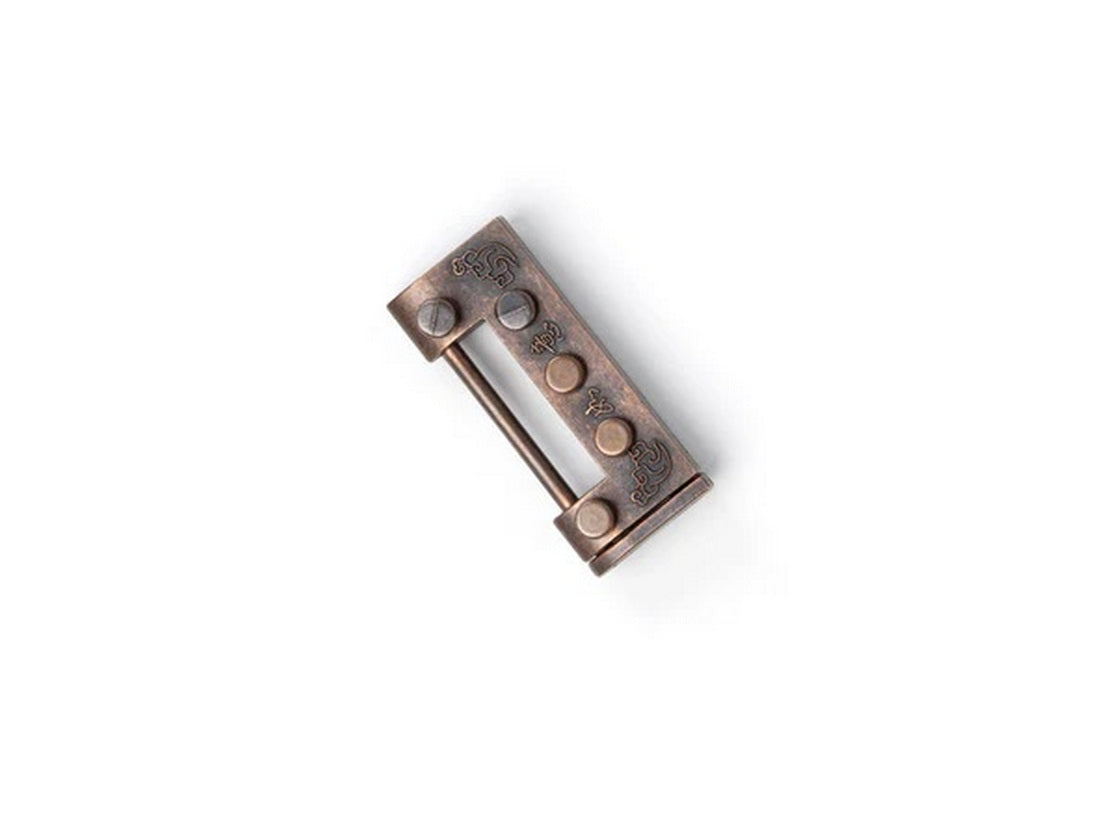 Traditional bronze puzzle lock featuring a sliding bar shackle and engraved designs, angled on white
