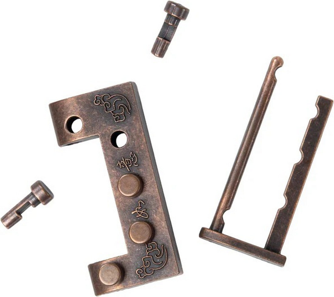 Intricate, disassembled bronze metal puzzle pieces, including an engraved L-plate and various locking pins