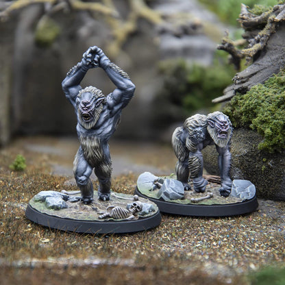 Two detailed grey cyclops-ape miniatures. One stands, fists raised; the other crouches, snarling.