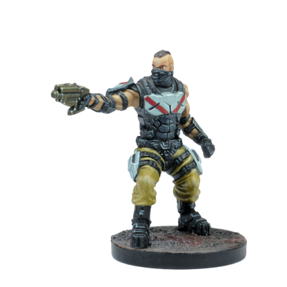 A painted miniature of a masked character in tactical gear with a mohawk, aiming a sci-fi blaster