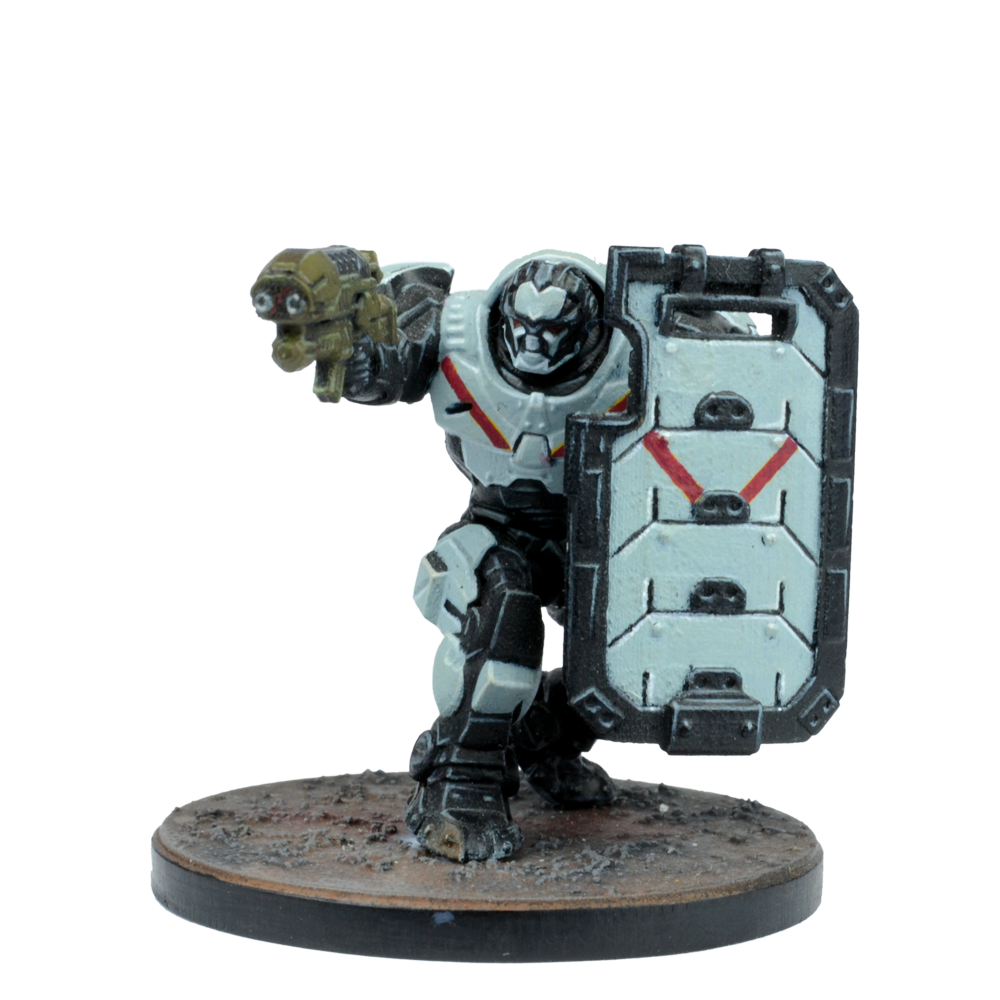 A miniature grey and black power-armored sci-fi figure holds a gold gun and a large shield with red markings