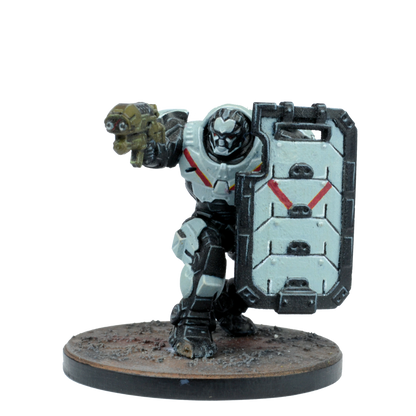 A miniature grey and black power-armored sci-fi figure holds a gold gun and a large shield with red markings