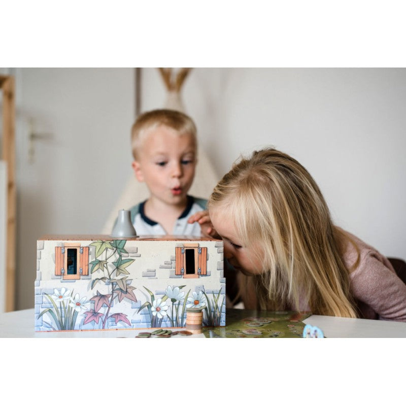 Close-up of the Peek-a-Mouse game box featuring illustrated mice peering through windows and holes in a yellow house