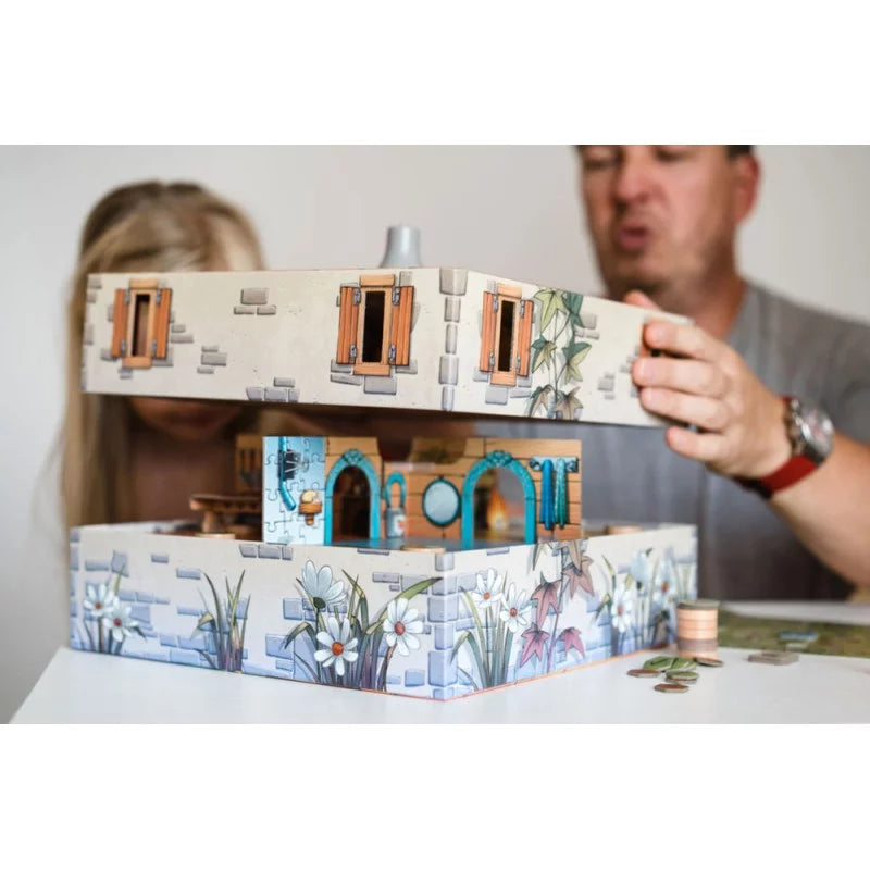 Game setup of Peek-a-Mouse with the assembled house structure and game elements placed around it, ready for play