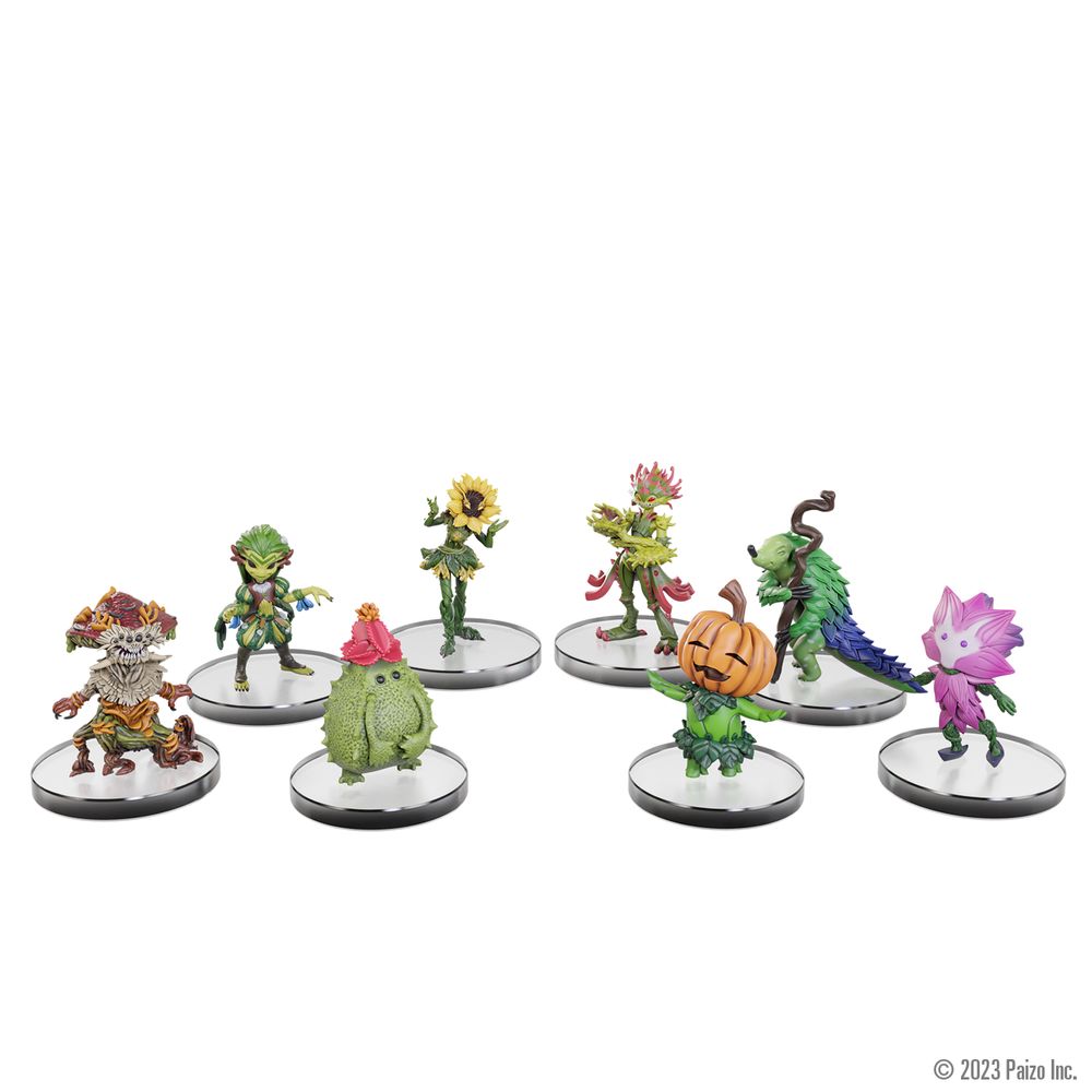 Eight colorful plant-themed fantasy miniatures, including pumpkin, sunflower, and leafy creatures, on clear bases