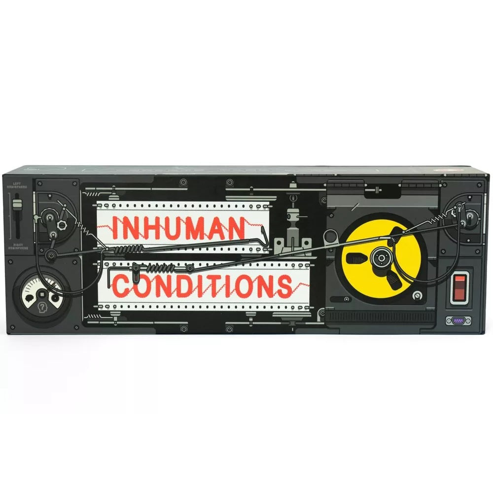 A black and grey machine with a yellow tape reel, displaying &quot;INHUMAN CONDITIONS&quot; in red on two white readouts