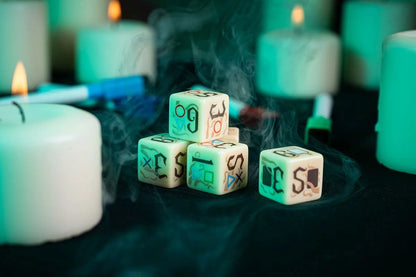 Stack of custom RPG dice with occult symbols, shrouded in smoke and surrounded by glowing white pillar candles