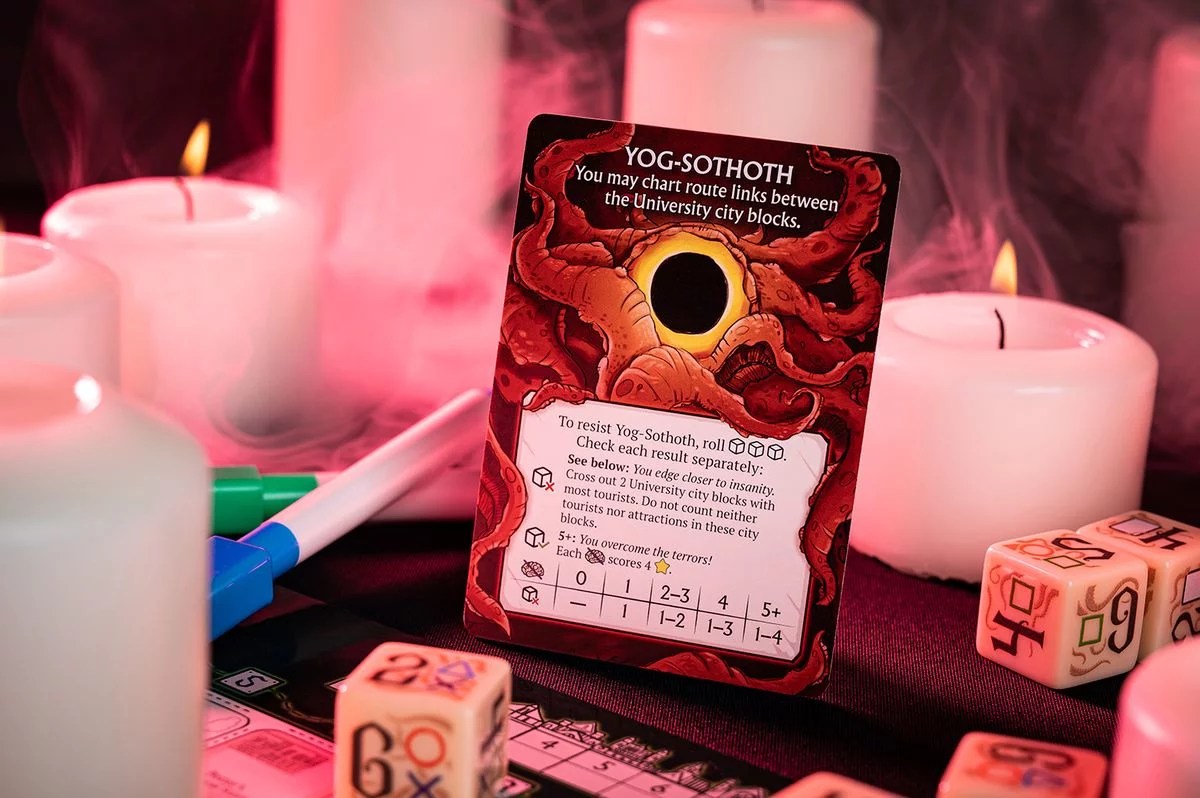 Yog-Sothoth card with red tentacles and a void, surrounded by glowing white candles, dice, and pink smoke. Tabletop horror game