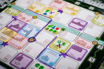 Close-up of a board game map showing colourful location tiles like "Miskatonic University," "City Hall," and "Museum of Occult Sciences," connected by purple path lines
