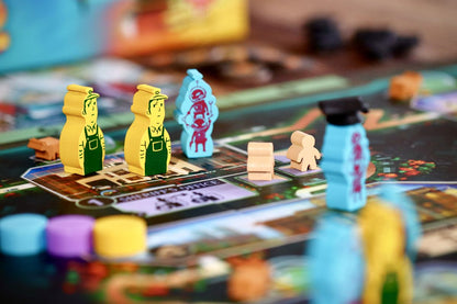Yellow and blue custom meeples on a board game map near the Sheriff's Office, with wooden tokens and cubes