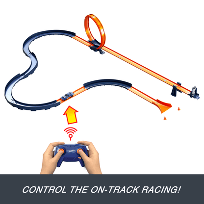 Hands use a remote to control a blue Hot Wheels car on an orange track featuring a loop and finish line