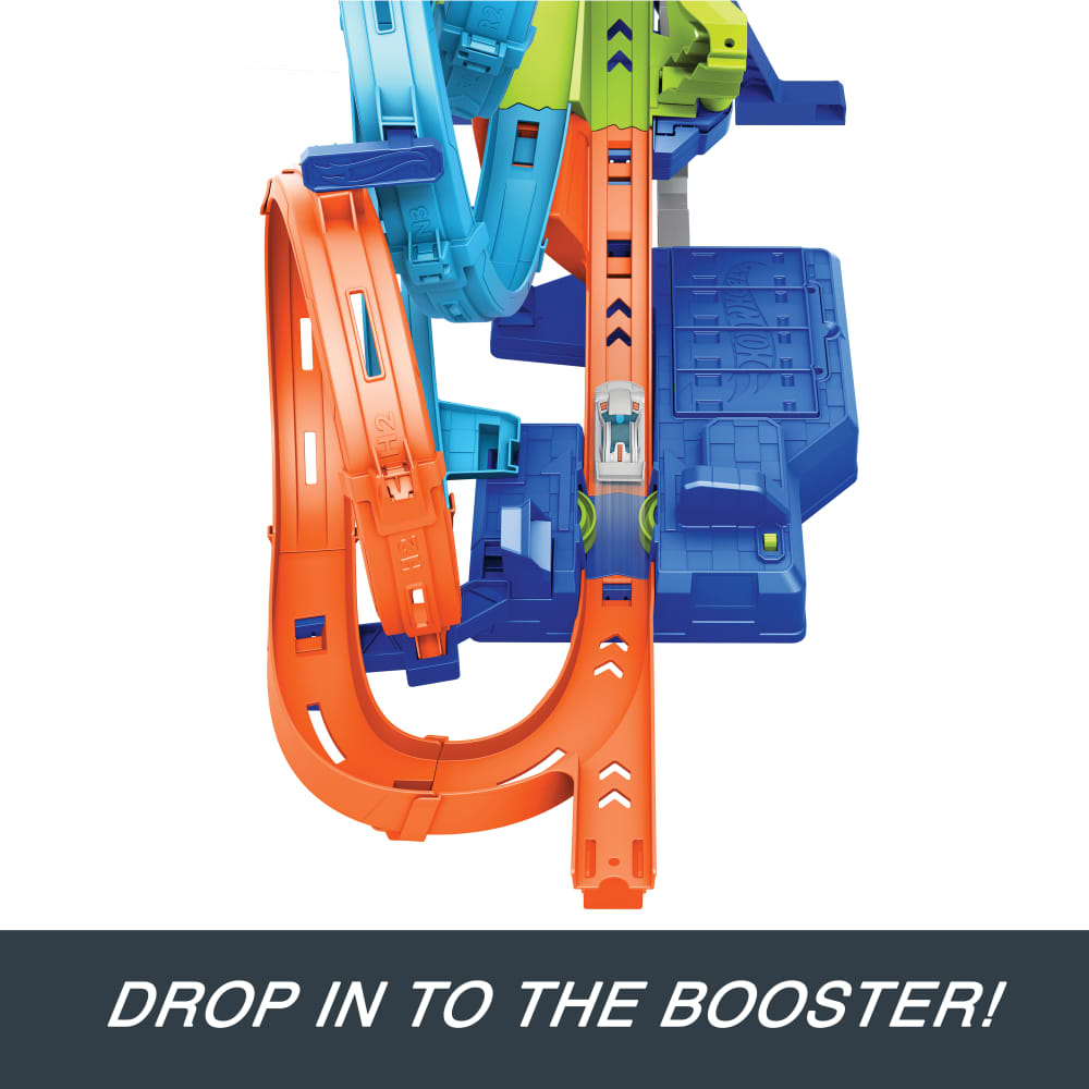 White Hot Wheels car on vibrant orange, blue, and green track set, dropping into booster
