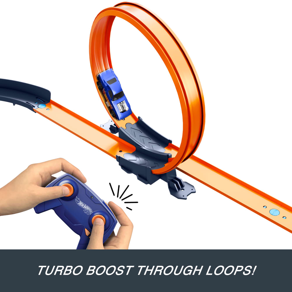 Blue Hot Wheels car boosting through an orange loop track, controlled by a remote