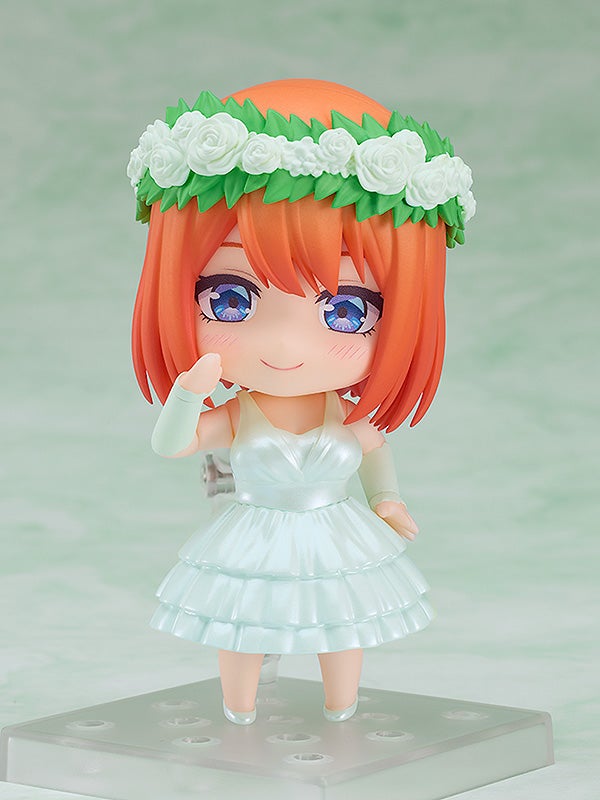Nendoroid Yotsuba Nakano figure in a white layered dress and floral crown on a clear stand