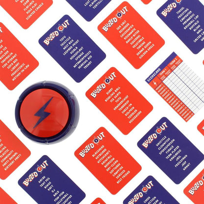 A Buzzed Out game laid out: a red lightning bolt buzzer surrounded by red and blue word cards and a scorecard.