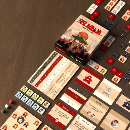 99 Ninja micro-game components spread on a wood table: box, scoring board, and many colorful ninja and samurai cards/tiles
