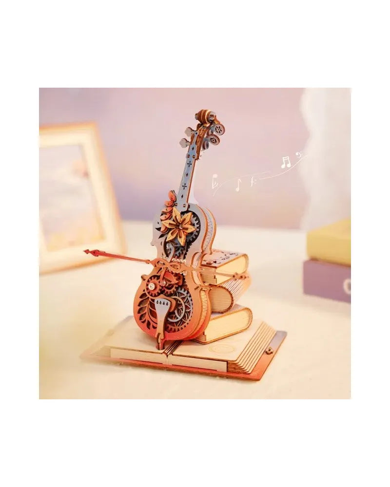 Wooden mechanical violin model with gears and flowers resting on a stack of books, with musical notes floating