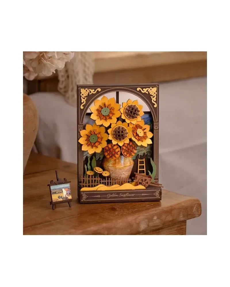 Layered wooden 3D puzzle diorama of sunflowers in a vase framed like a window, with a miniature easel