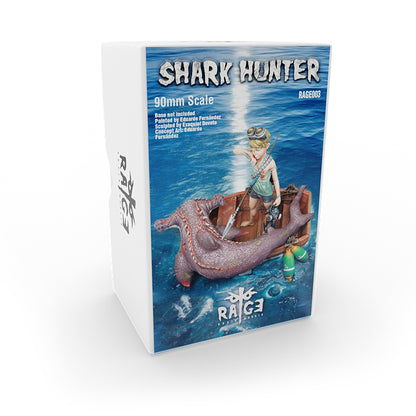 A product box for a resin figure features a boy in a small boat with a large defeated hammerhead shark in the ocean, with harpoons and diving gear