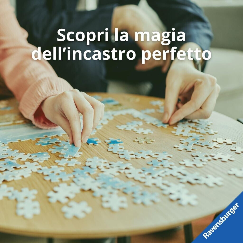 Two hands assembling a light blue jigsaw puzzle on a wooden table