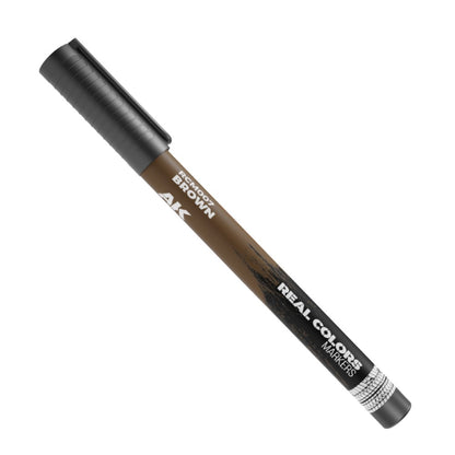 A brown AK Real Colors marker with a dark cap, angled on a white background