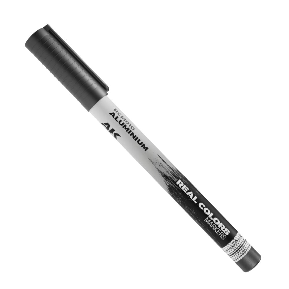 A black "AK Real Colors" marker with "Aluminium" label, positioned diagonally on a white background