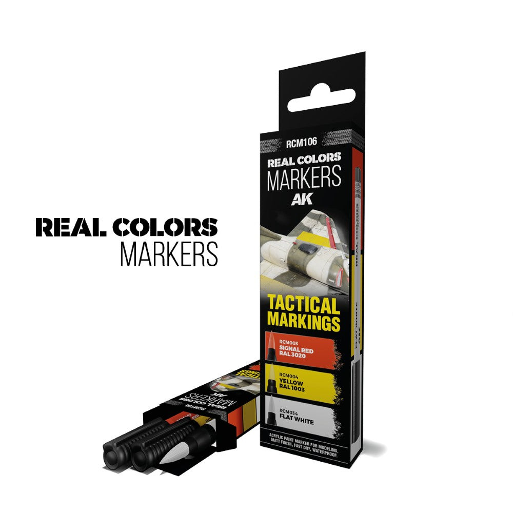 Two AK Real Colors Markers boxes: one advertises tactical model paint (red, yellow, white); the other is open, revealing two black markers