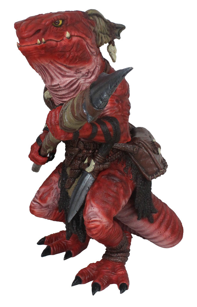 Red, scaly reptilian kobold figure with fangs and yellow eyes, holding a hooked axe and a dagger