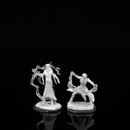 Two unpainted WizKids Critical Role miniatures: a robed male cultist and a dynamic female chosen, both with translucent magical effects, stand on a reflective black surface