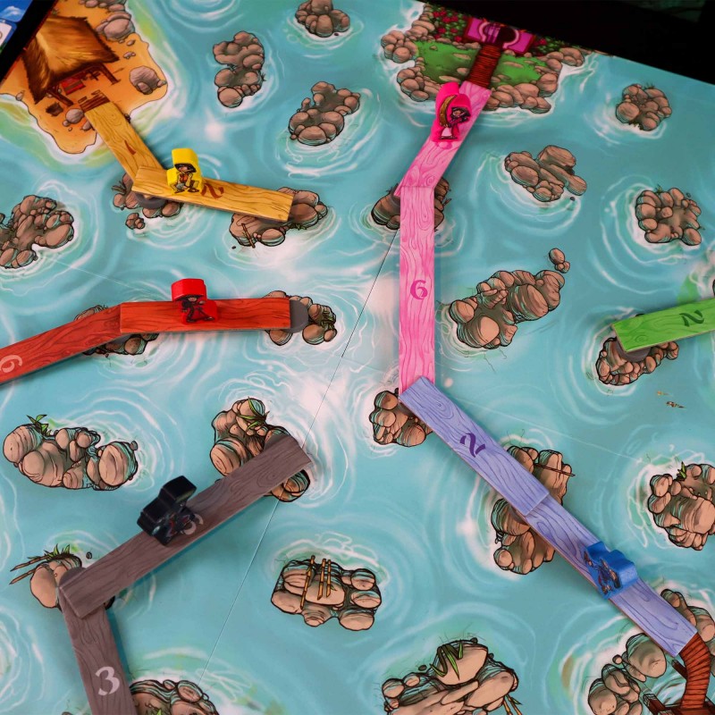River Dragons board game setup showing players building bridges across a river of swirling water and rocks