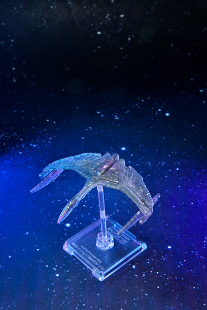 Translucent, bird-like spaceship model glowing blue and purple, displayed on a stand against a dark starry background