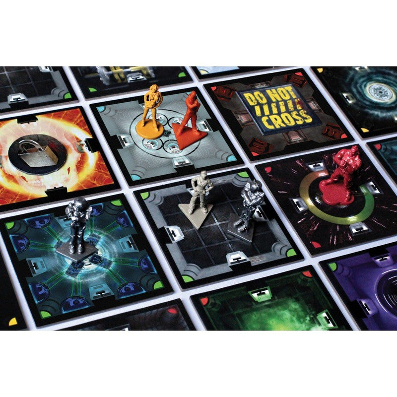 Close up of a board game with square tiles depicting futuristic scenes and small figures representing characters