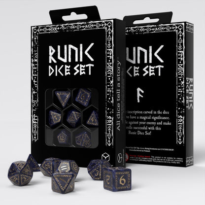 A Runik Dice Set with dark blue and gold runic polyhedral dice, some in a black display box, others scattered below