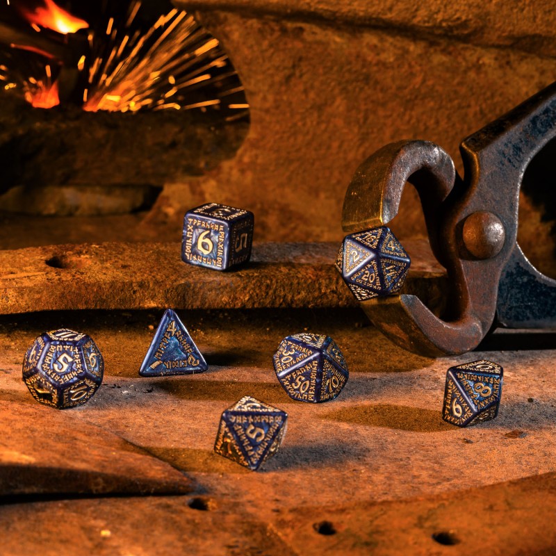 Dark blue and gold dice on a forge surface, blacksmith&#39;s tongs hold one die, with glowing sparks nearby