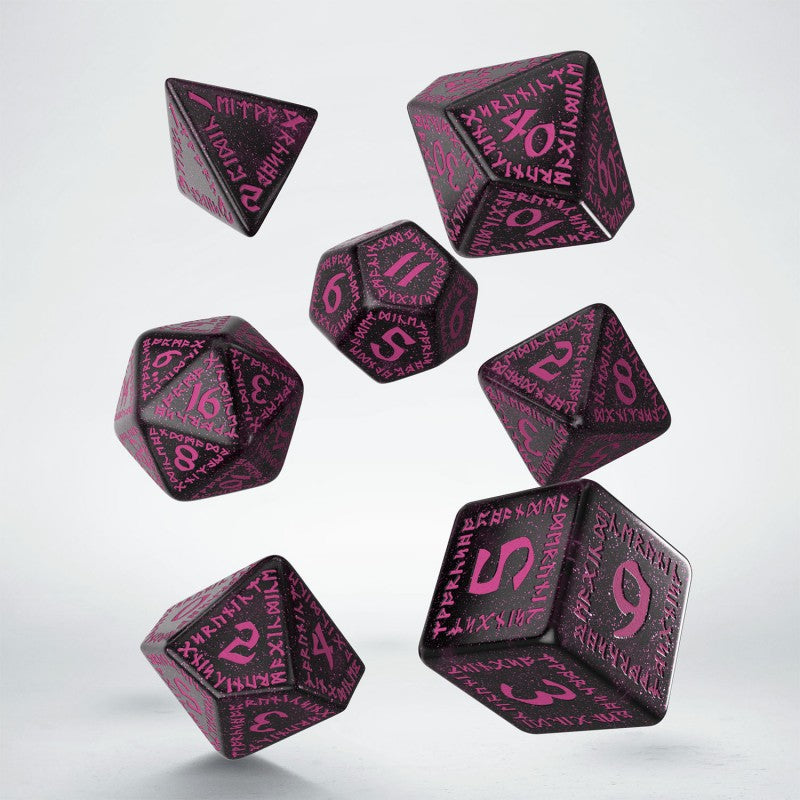 Seven black speckled dice with magenta numbers and symbols falling against a light background