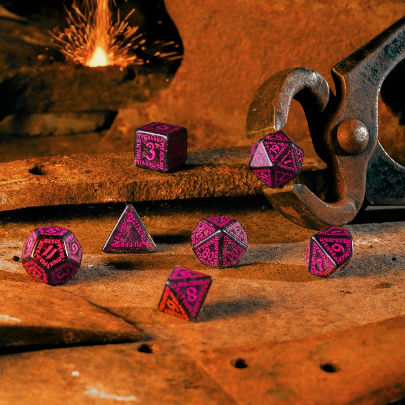 Dark polyhedral dice with bright pink markings lie on rusty metal, a forge sparking in the background