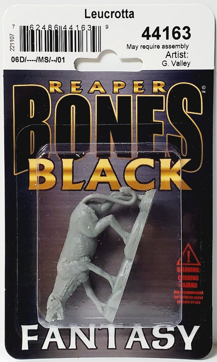 A packaged Reaper Bones Black Leucrotta miniature, a gray horned beast, visible through clear plastic on a dark and gold card