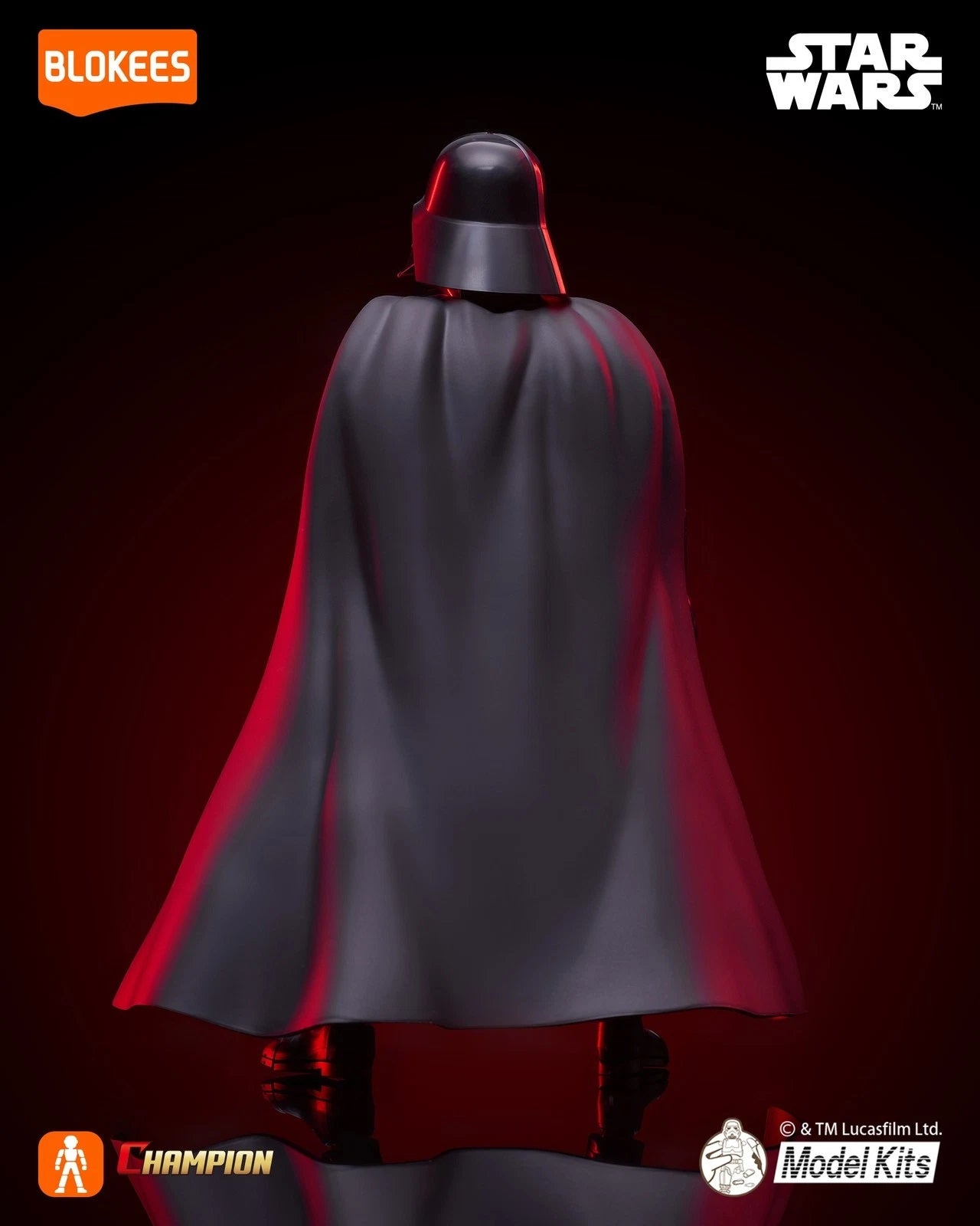 Dramatic rear view of a Darth Vader model figure showcasing the large black cape and helmet against a dark, red-lit background