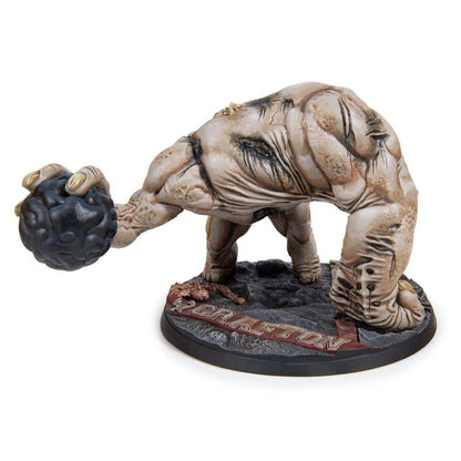 Grafton Monster collectible figure, a pale, muscular beast holding a black, brain-like sphere on a detailed base