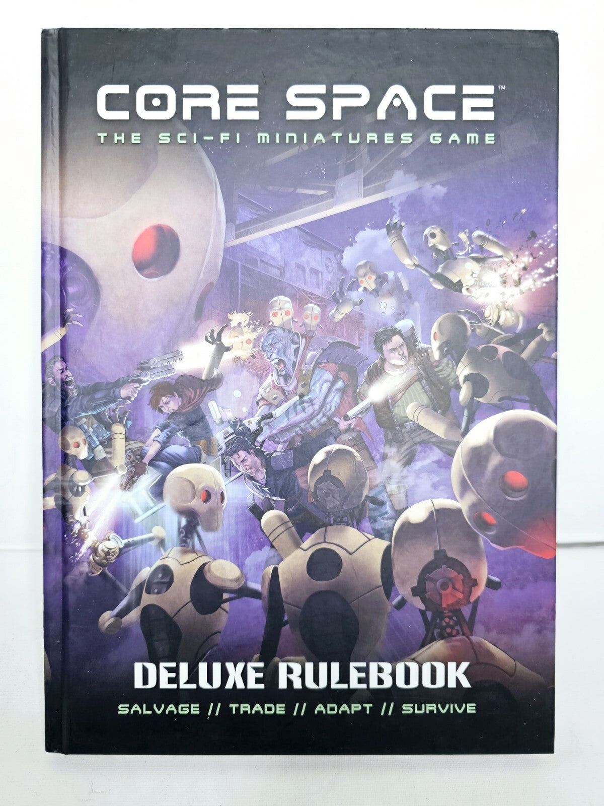 Intense sci-fi battle on Core Space Deluxe Rulebook cover: Humanoids fight tan robots with glowing weapons